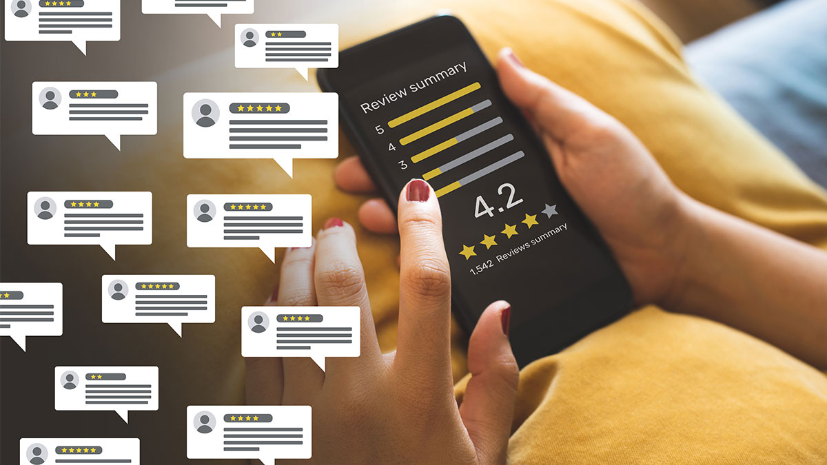 Woman uses her smartphone to read customer reviews of a local small business.