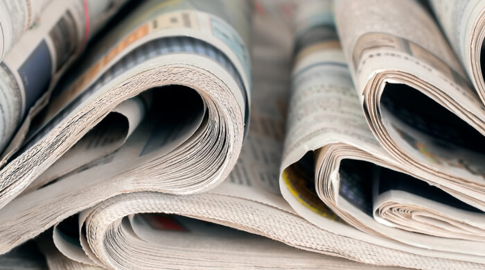 A collection of rolled up newspapers.