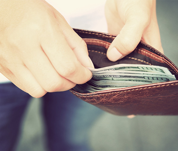 Man with wallet pulling out money