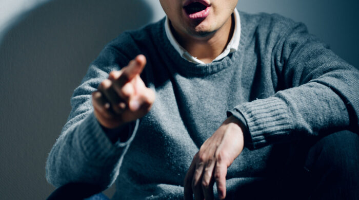 A man points his finger and expresses accusations of defamation per se